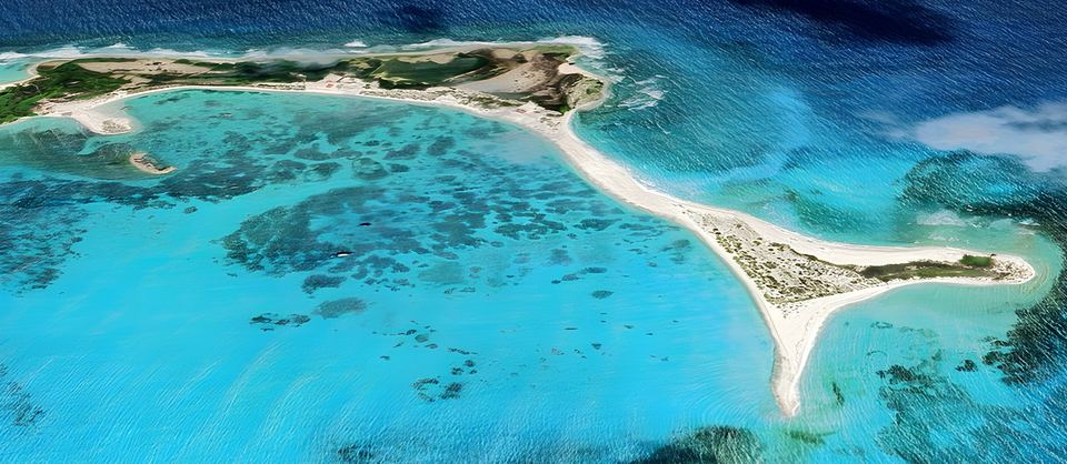Aerial view of the horseshoe-shaped sand spit of Cayo Herradura and its turquoise bay