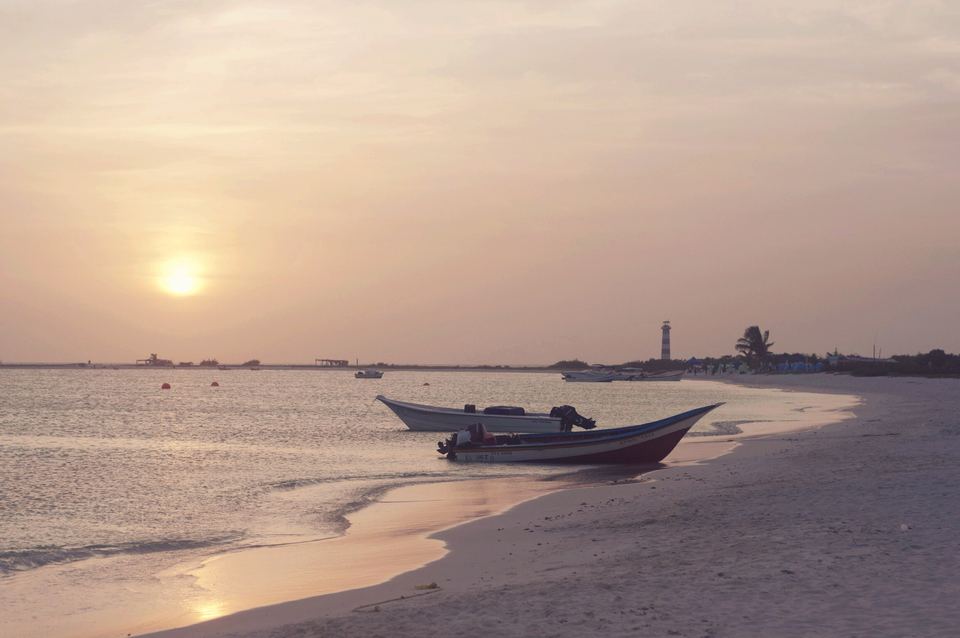 Sunset on Cayo Herradura with fishing boats pulled up on the sand